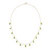 A PERIDOT NECKLACE in 18ct yellow gold, the trace chain suspending thirteen briolette cut peridot...