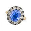 A BURMA NO HEAT SAPPHIRE AND DIAMOND CLUSTER RING in 18ct yellow gold and silver, set with a cush...