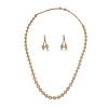 A PEARL NECKLACE AND EARRING SUITE in yellow gold, the necklace set with graduating cultured pear...