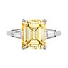 A 5.46 CARAT FANCY INTENSE YELLOW DIAMOND RING in platinum, set with an emerald cut yellow diamon...