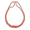 A TWO ROW CORAL BEAD NECKLACE in 9ct yellow gold, comprising two rows of graduated coral beads ra...