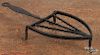 Wrought iron trivet, 19th c., 13 1/2'' l., together with a peel, 32 1/2'' l.