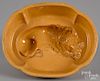 Yellowware lion food mold, 19th c., 3 1/4'' h., 8 1/4'' w., 6 5/8'' d.