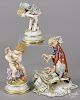 Three German porcelain figurines, to include a putti with blue crossed swords Meissen mark