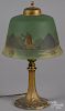 Gilt metal parlor lamp, early 20th c., with a reverse painted shade, 14'' h.