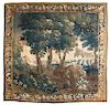 A Flemish Silk and Wool Verdure Tapestry 9 feet 10 inches x 7 feet 5 inches.