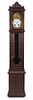 * A Continental Walnut Tall Case Clock Height 97 inches.