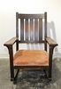 A Stickley Oak Rocking Chair. Height 37 1/4 inches.