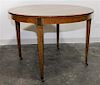 * Baker Furniture, AMERICAN, MID 20TH CENTURY, a circular dining table with two leaves