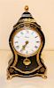 A Gilt Decorated Ebonized Mantel Clock. Height 12 1/2 inches.