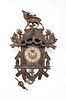 Carved cuckoo clock with stag pediment and carvede