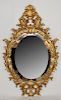 Ornate gilt oval mirror