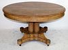 American round oak pedestal table with 3 leaves.