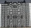 Scrolled iron gate set with bronze accents.