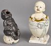 Enameled iron baby in an egg still bank, 7 1/4'' h., together with a spelter figure of a baby