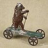 Painted tin bear on a platform pull toy, 3 1/4'' h.