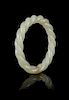 A Carved Celadon Jade 'Robe Twist' Bangle Diameter 3 inches.