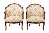 A Pair of Louis XV Style Upholstered and Carved Wood Bergeres Height 34 1/2 x width 24 x depth 27 inches.