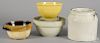 Four pieces of stoneware and pottery, to include a McCoy yellow glaze bowl, tallest - 8 1/2''.