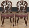 Pair of Victorian walnut side chairs with elaborately scalloped and pierced backs.