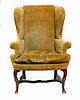 Queen Anne Carved Walnut Upholstered Winged Armchair.