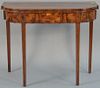 Federal mahogany games table having D shaped top, the conforming frieze with line and panel inlays all set on square tapered 