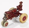 Arcade cast iron McCormick Deering Farmall tractor with a painted driver, white rubber tires