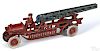 Dent cast iron water tower fire truck with a painted driver, 15 1/2'' l.