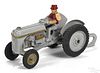 Arcade cast iron Ford 9n tractor with a plow and a painted driver, 8 1/2'' l.
