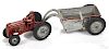 Arcade cast iron tractor with a bottom dump trailer and a painted driver, 15'' l.