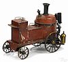 Painted tin live steam fire pumper with brass wheels and a rear mounted single cylinder engine