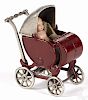 Kilgore cast iron baby carriage with a celluloid baby doll, 5 1/2'' h.