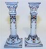 * A Pair of Delft Candlesticks. Height 9 3/4 inches.