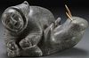 A SOAPSTONE CARVED INUIT FIGURE WITH WALRUS