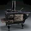 A CHILD'S CAST IRON TOY “BEAUTY” COOK STOVE