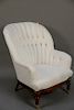 Barrel back armchair with custom white upholstery.