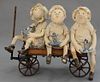 Early wooden wagon with three children. ht. 35in., lg. 48in.