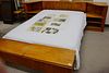 Group lot to include a contemporary teak queen sized bed with two night tables and attached double lift top chests and a pair