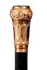 25. Gold Dress Cane- Dated 1875- An ornate unsigned 14 kt gold handle with a black and white quartz disc atop, inscribed “R