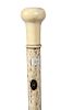 49. Nautical Whalebone Cane- Ca. 1865- A carved whale’s tooth handle with a baleen disc atop, two metal eyelets, beautiful 