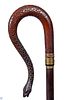 79. Gun Snake Cane – Ca. 1880 – A foreign carved 15” snake handle with brass attachments and dropdown trigger which has