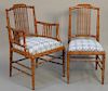 Set of twelve faux bamboo style dining chairs with blue and white needlepoint seats, two arm and ten sides.