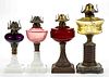ASSORTED PATTERN KEROSENE STAND LAMPS, LOT OF FOUR