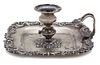 An American Silver Candle Holder, Howard & Co., New York, NY, 19th Century, having a shell and c-scroll border, loop handle, 