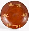 Pennsylvania redware plate, 19th c., with yellow slip decoration, 9 1/4'' dia.