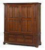 Pennsylvania or New York cherry schrank, late 18th c., with dentil cornice and raised panel doors,