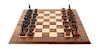 A Brown Patinated Metal "Range War" Chess Set, Leigh Aldrich, 1991 Height of tallest 3 inches.