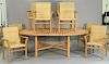 Janus et Cie and Donghia nine piece teak lot including Donghia oval table and eight Janus et Cie armchairs with woven seats a