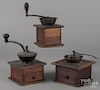 Three antique coffee mills, to include one marked Arcade Mfg. Co., one branded J. Kinzy, and an