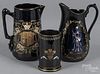 Two basalt ground pitchers and a beaker decorated with Victoria and Albert, Victoria's diamond jubil